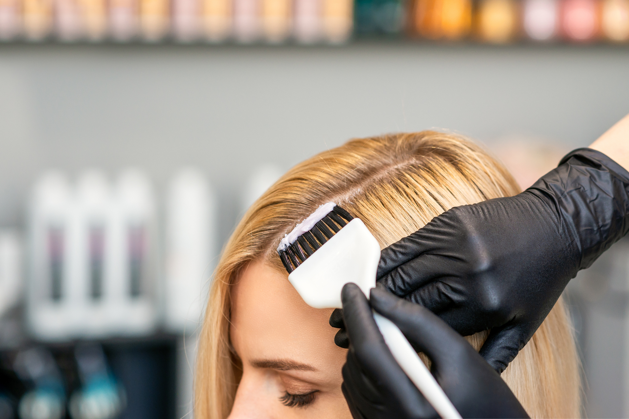 Hairdresser applying low-ammonia organic hair color at MaryLuz Hair Salon